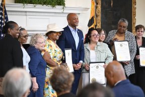 Governor Moore in a photo with AFT Maryland awardees